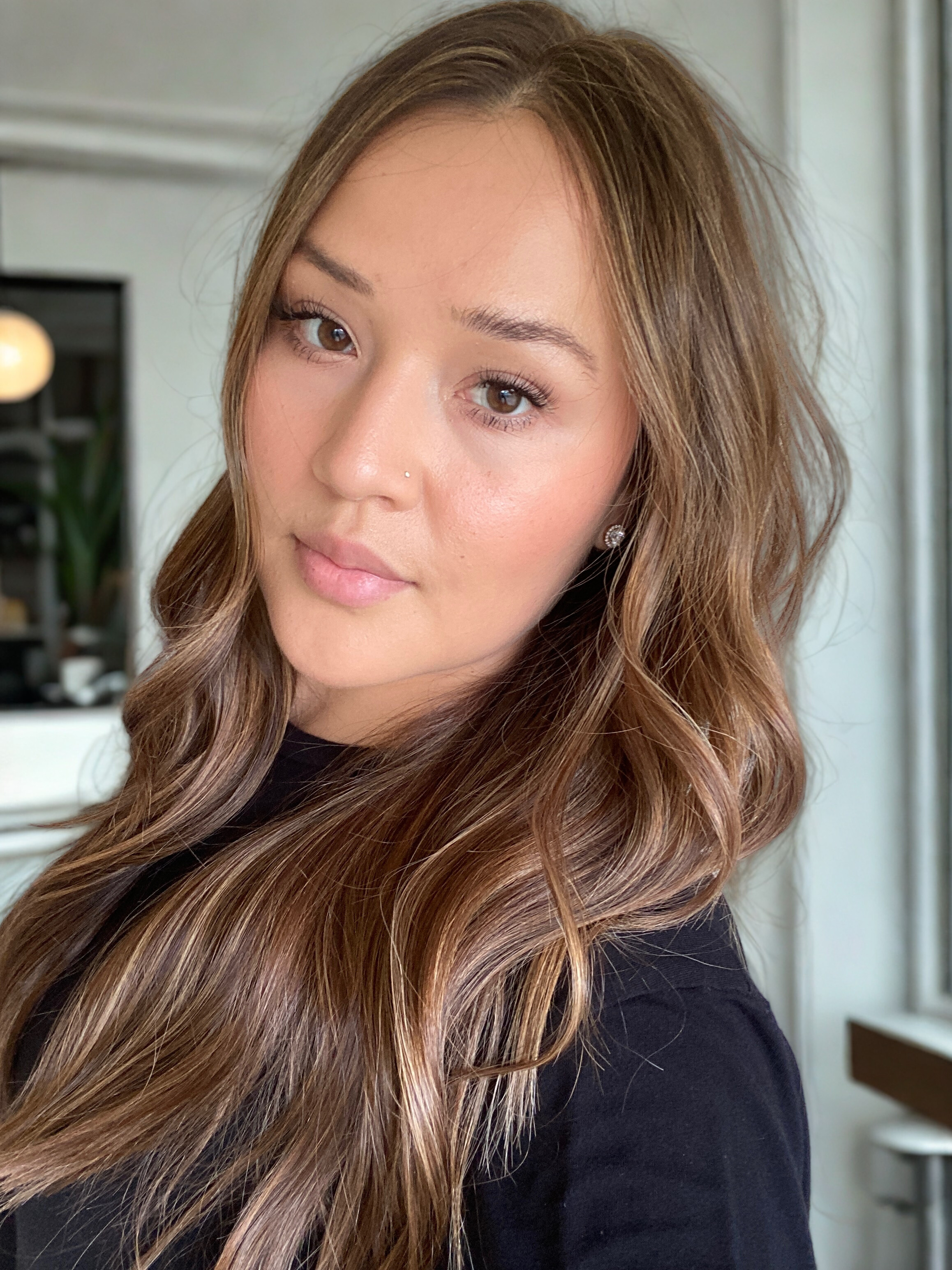 Smiling young woman with dark hair and full bangs